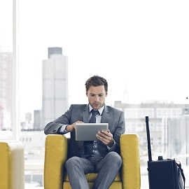Man in suit using his tablet