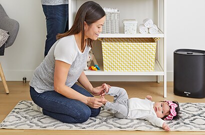 Mom in a nursery with a child. 