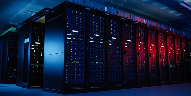 High-density data center with illuminated server racks optimizing speed and efficiency.
