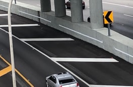 cars driving underneath ramps on busy interchanges