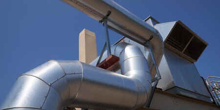 Large white industrial pipes connected together by joints.
