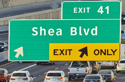 Guide sign on a busy highway.