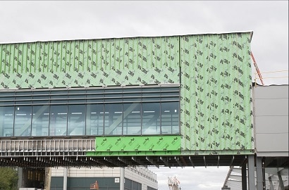 Elevated walkway under construction with building envelope visible