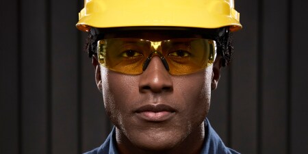 man wearing safety glasses with yellow lens
