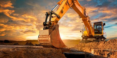 Excavator digging into dirt
