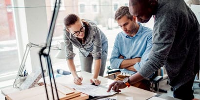 a group of architects reviewing blueprints
