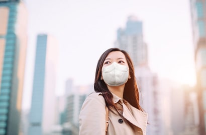 A woman wearing a 3M Particulate Respirator 9513