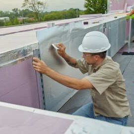 Man applying 3M VentureClad Insulation Jacketing System