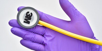 Purple gloved hand holding auscultation
