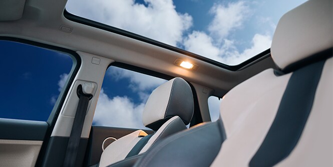 Interior view of a vehicle looking out of the sunroof using 3M™ Automotive Comfort Solar Film (ACSF).
