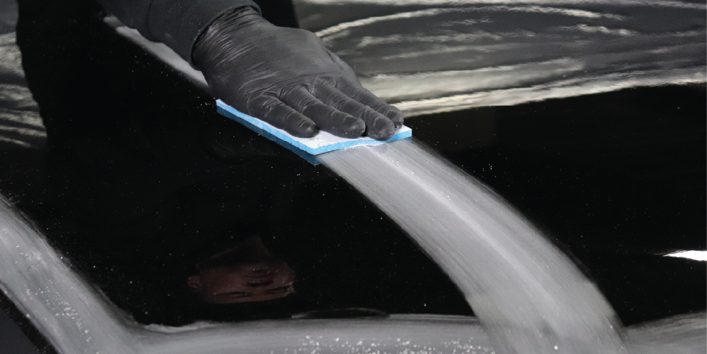 arm using 3M flexible foam abrasive on vehicle hood
