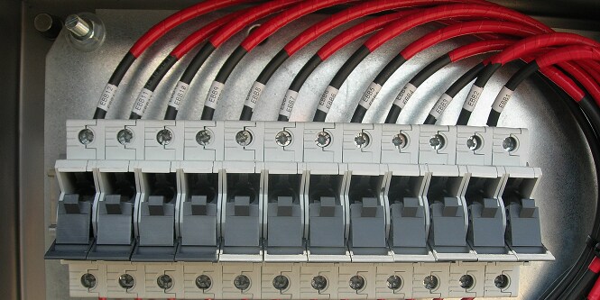 image of breakers with color coded electrical cables
