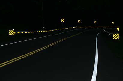 road turn with yellow arrow signs
