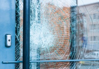 close up of glass door with cracks 
