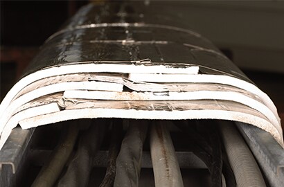 Mitigating fire damage in an oil refinery with 3M&rsquo;s protective wrap system.