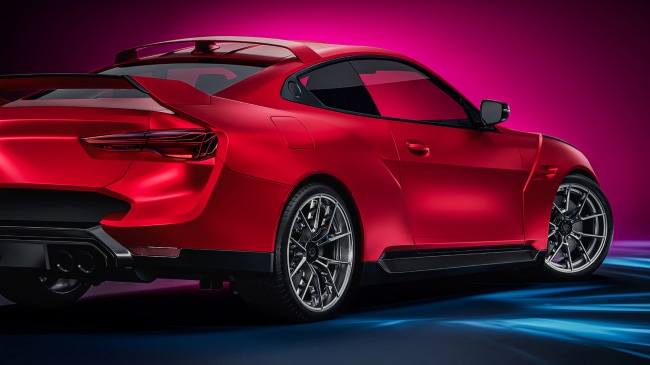 Rear passenger‑side view of a red sports car with complex body lines, showcasing conformable automotive film.
