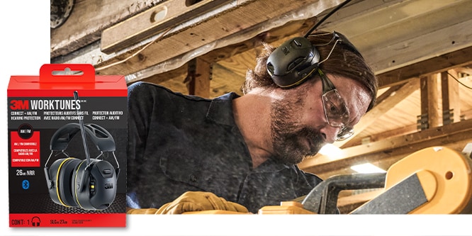 A man wearing a beanie and 3M™ WorkTunes™ Connect + AM/FM Hearing Protector while using power tools.
