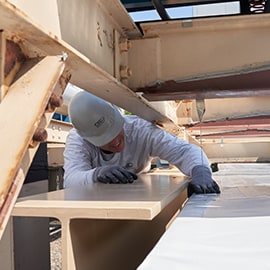 contractor applying film on building vents