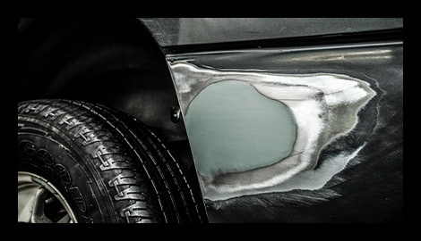Truck fender with a dent repaired and sanded smooth using Bondo body filler.