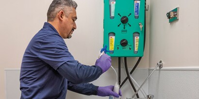 Cleaning Staff diluting a chemical concentrate through the 3M(tm) Flow Control Chemical Management Dispenser