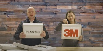 Two individuals sorting boxes labeled 