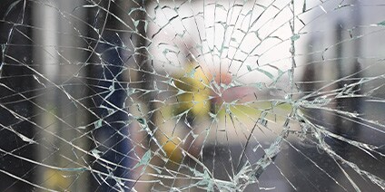 Close up photo of cracked glass window
