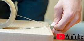 Image of a person starting a tape seal on a corrugated carton
