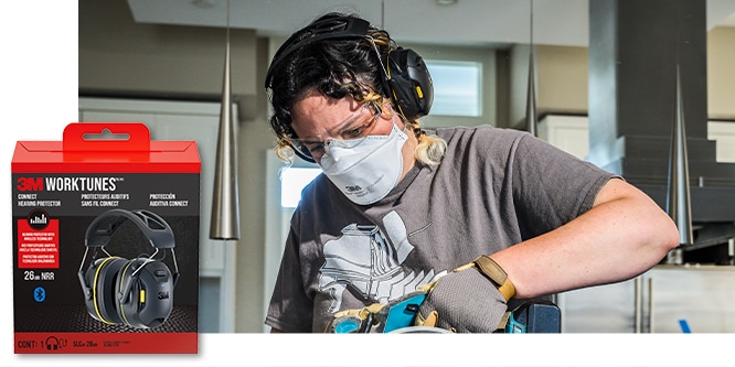 A woman wearing 3M™ WorkTunes™ Connect Hearing Protector and a mask while using a sander.
