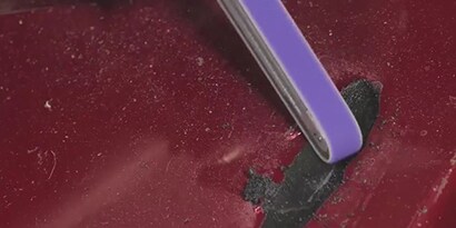 preparing the surface of a bumper with a file belt tool
