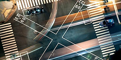 Busy junction at night from above
