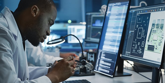 Scientist inspecting industrial interconnect components
