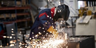 Construction worker wearing a 3M safety helmet on a job site.
