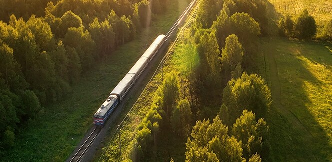 Hybrid passenger train with bold 3M graphic film design on the rail tracks.
