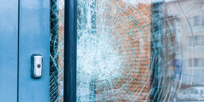 close up of glass door with cracks
