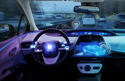 Decorative image of highway with automobiles and depiction of advanced driver assistance systems.
