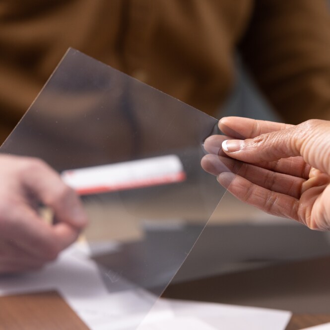 Hand holding a sample of window film

