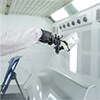 paint technician spraying parts off