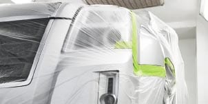 technician masking a car with 3M green tape