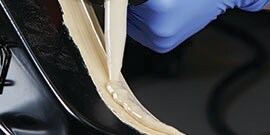 applying spray seam sealer to protect weld site