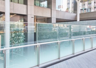 Glass railing with decorative glass finish applied 
