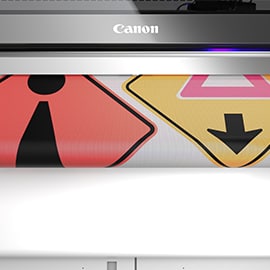 two traffic signs being printed on the Canon M-series printer.