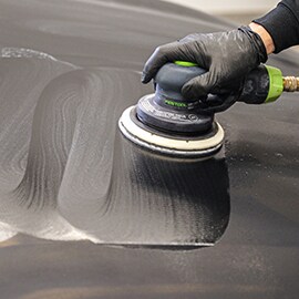 Technician using 3M™ Trizact™ Hookit™ Foam Abrasive Disc and Festool Random Orbit Sander