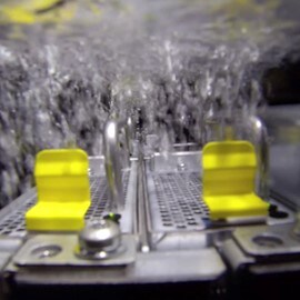 Servers being submerged in 3M™ Novec™ Engineered Fluid