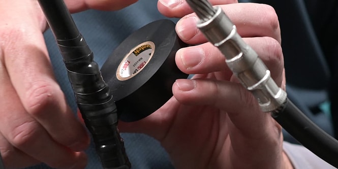 electrical splice being wrapped in electrical padding
