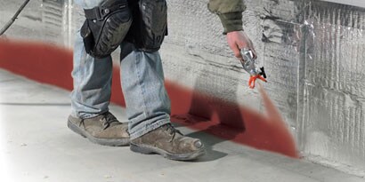 Construction worker spraying 3m firedam spray
