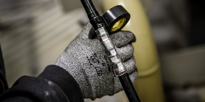 worker wrapping irregular-shaped electrical splice in Super 33+ tape
