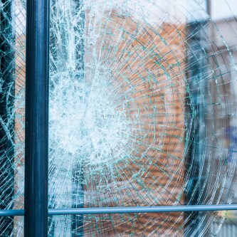 close up of glass door with cracks 
