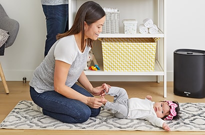 Mom in a nursery with a child.