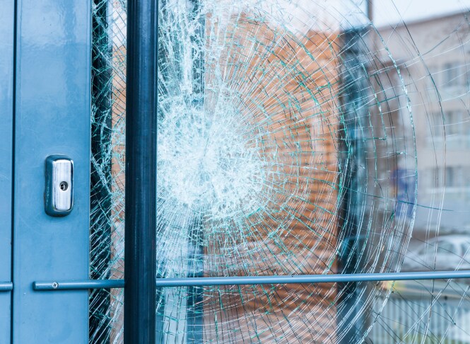 close up of glass door with cracks

