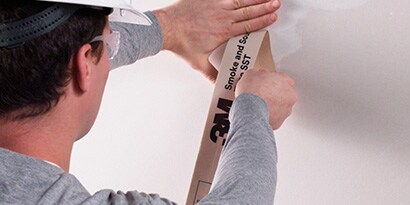 3M™ Smoke and Sound tape applied easily to a wall-to wall-construction joint.
